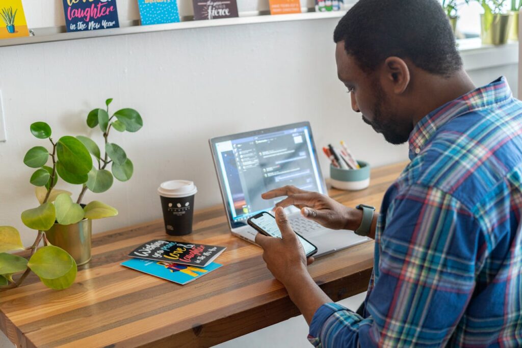 A Man in Blue Plaid Long Sleeves Using a Smartphone